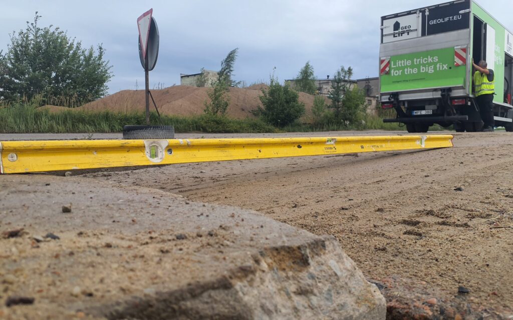 Unstable road surface caused by subsoil settlement prior to soil stabilization
